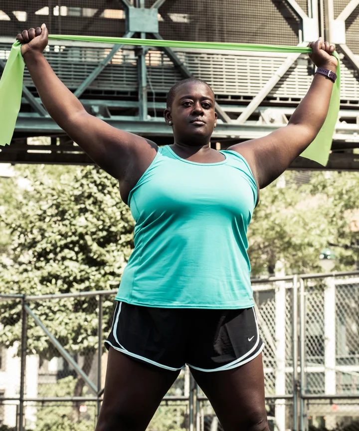 Woman Plus Size in Gym Doing Exercises with Running Training App